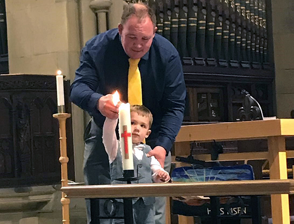 Child lighting a candle